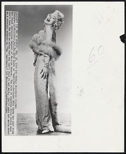 Edie Adams as 'Marilyn' -- Satirist Edie Adams has quit doing her famed impression (above) of Marilyn Monroe. The wife of comedian Ernie Kovacs says she's done the bit so often that she can't face it anymore. She'll make her movie debut as a straight actress in "The Apartment."