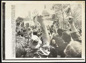 March with Raised Fists -- Peace marchers parade to the Capitol today for an antiwar rally.