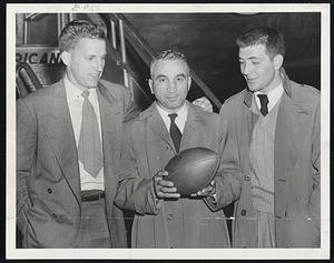 Big Three of Terriers, Bill Pavlikowski, Coach "Buff" Donelli and Capt. Lou Salvati, check into East Boston Airport after flying trip from Pittsburgh where B. U. humbled Duquesne, 21-7, in season's opener.