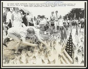 Washington: Youngsters plant miniature American Flags in a pattern spelling out the letters USA on the Ellipse behind the White House 7/4 during "Honor America Day" observance.