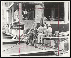 Time for Lunch-Diver James Devaney (second left) surfaces along with brotheer-in-law Gordon Winrow (in helmet) after morning of removing silt.