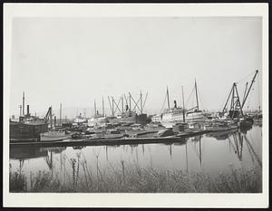 This Photo shows four lumber boats, still fully loaded, tied up at Long Beach, Cal., by the maritime strike.