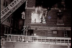 Heavy fire showing from the second floor on the Third Street side of the building