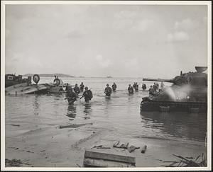 U.S. Marines wade ashore on Guam as the aerial and naval bombardment continue