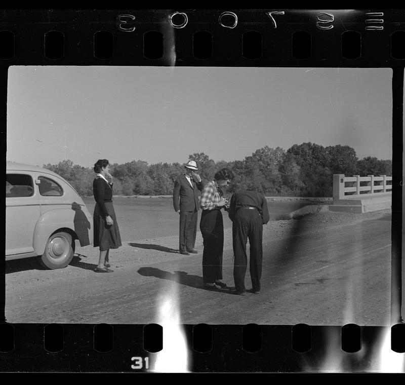 Group of people next to car in the desert, likely New Mexico