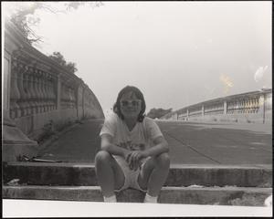 Young woman sitting on bridge steps