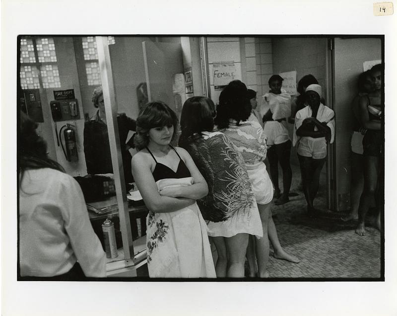 A teenager waits outside a locker room