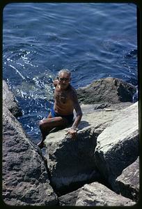 Man swimming from rocks, Naples, Italy