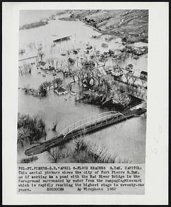 8-Flood Reaches S.Dak. Capitol: This aerial picture shows the city of Fort Pierre S.Dak. as if nesting in a pond with the Bad River Bridge in the foreground surrounded by water from the rampaging Missouri which is rapidly reaching the highest stage in seventy-one years.
