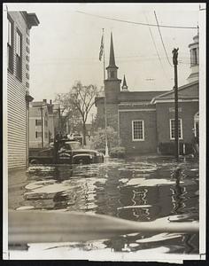 Hub Deep- A city truck carries workers through one of the flooded streets of Peabody, as water started to recede.