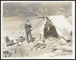 Gold is Where You Find it. In his search for "Pay Dirt", the prospector pitches his camp near his workings on the shores of the Yukon river and pans or sluices the goldbearing sand and gravel for the yellow lakes and nuggets. His rifle hangs from the tentpole, and his living room is the great outdoors.