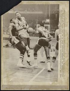 Boston-Celtics-Lakers-Celtics' Bill Russell (2nd,L) is fouled and loses ball as he goes between Lakers' Jim Barnes (L) and Tom Hawkins (R), 2nd period action, Boston Garden (1 1/2). Celtics won game 133-108.