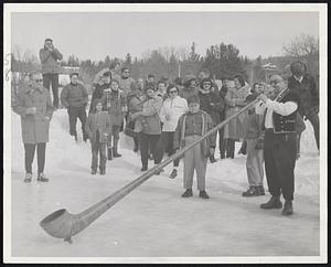 Music, Not Smoke is being blown on this 15-foot Swiss Alphorn, a rarity even in the Alps now. Spectators at recent "Spring Fling" weekend at Jackson, N.H., enjoy the efforts of Charles Zumstein, innkeeper, as he plays the instrument. The horn is little used currently, because of lack of players.