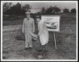 Ground Breaking - Charles F. Adams, president of Raytheon Manufacturing Co., digs first shovelful of dirt at site of new $1,700,000 modern flight test facility at Hanscom Field, Bedford. At left is Navy Capt. Willie M. Dickey, representing the Navy. In background is sketch of finished test facility.