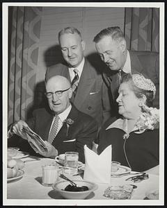 Half Century of Service to Western Union ended last night for W. M. Powers (seated, left), retiring as assistant chief operator here. He was given a testimonial dinner at the Hotel Essex. Also pictured are Mrs. Powers; Vernon T. Adams, traffic manager (left), and Frederick J. Carew, toastmaster.