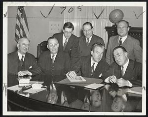 Attend Mayor's Meat Famine Conference - Officials of Federal government, the meat industry and labor confer with Mayor Kerrigan about Boston's grave meat shortage. Front row (left to right) William E. Hale, deputy administrator of OPA; Thomas H. Menten, New England district manager of Swift & Company; Mayor Kerrigan, and Fred A. McDermott, OPA regional rationing executive. Back row: John E. Mitchell, field representative of the United Packinghouse Workers of America, CIO; Harry B. Weiner, business agent of local 11 UPWA, and Bernard L. Kolovson of the American Beef Company.