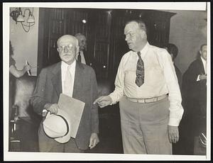 Henry Whittemore, vice-president of Meredith & Grew, who testified yesterday before the finance commission, confers with Mayor Mansfield at the hearing.