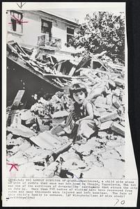 Lonely Survivor Of Quake -- Bewildered, a child sits alone on pile of rubble that once was her home in Skopje, Yugoslavia. The tot was one of the survivors of devastating earthquake that struck the city on July 26. More than 700 bodies of victims have been recovered from ruins and many thousands were injured and left homeless. The fate of this child's family is unknown.