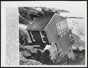 Heads for Sea--Torrential rains which undermined a cliffside road here sent this three-story house belonging to Richard Flemming of Riverside sliding down the face of a 60-foot cliff. Although severely damaged, the house came to a halt before it smashed on the beach below. No one was in the house at the time.