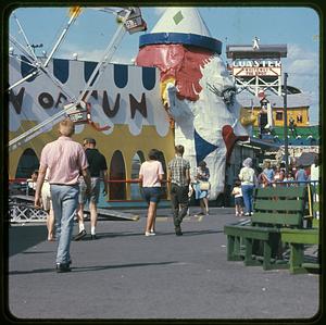 People walking through amusement park
