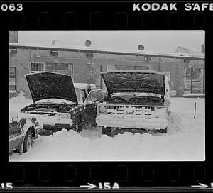 Man working on car during snow storm