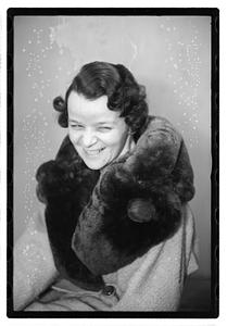 A woman with a fur scarf around her neck