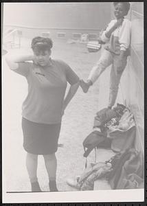 Anna posing with another young woman by a pool