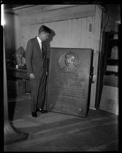 JFK examines plaque in memory to his grandfather John F. Fitzgerald