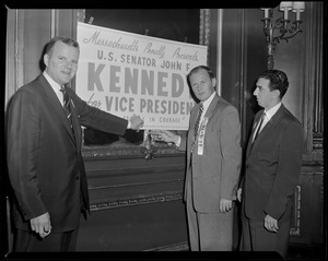 Supporters hang sign for JFK at convention