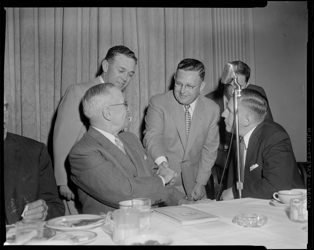 Truman, flanked by Curley & Furcolo, shakes hands during his breakfast at the University Club