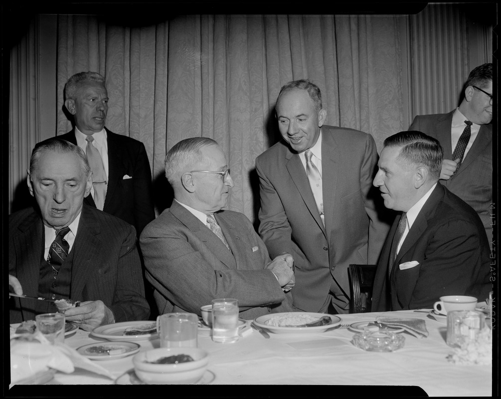 Truman, flanked by Curley & Furcolo, shakes hands during his breakfast at the University Club