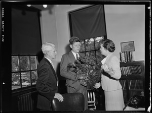 JFK receives bouquet of flowers from the mayor of Waltham which was intended for Jackie who could not come for the occasion