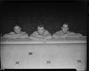 Three swimmers at the side of McCurdy Natatorium