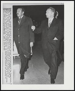 Off on Mission to Africa-United Nations' secretary-general Dag Hammarskjold, right, walks toward plane at New York's Idlewild Airport tonight as he prepares to leave on mission to Africa. With him is Mekki Abbas, executive secretary of the U.N. Commission for Africa, who saw Hammarskjold off on 19-day journey. The secretary-general will go to Leopoldville in The Congo and then to the Union of South Africa, the United Arab Republic and possibly to India.
