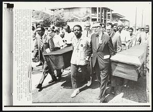 Protest Slayings - Rev. Ralph Abernathy, president of the Southern Christian Leadership Conference, (center-left) and Leonard Woodcock, newly elected president of the United Auto Workers Union, clasp hands as they carry caskets protesting the deaths of students at Kent State University, Jackson State College, and the six deaths at racial disorders at Augusta, Ga. A large protest march today in Atlanta climaxed with a rally at Morehouse College.