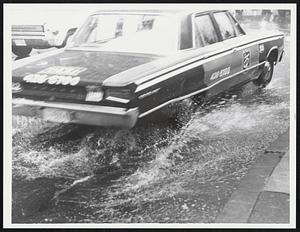 A car driving through flooded street