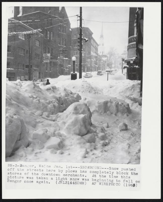 Bangor, Maine. - Snowbound - Snow pushed off the streets here by plows has completely block the stores of the downtown merchants. At the time this picture was taken a light snow was beginning to fall on Bangor once again.