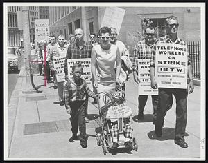 It was a nice day for a stroll, so picketing became a family affair today outside the New England Telephone Co. headquarters on Franklin St.