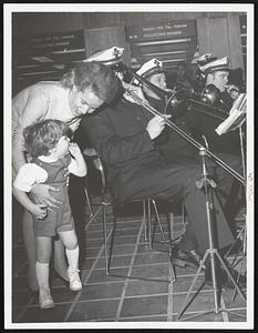 Mrs. Kevin White, wife of the mayor, and son Christopher, 2, enjoy the brassy sounds of the Fire Department Band.