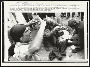 Victim of the Melee -- A youth felled during a confrontation between anti-war demonstrators and police in Berkeley yesterday, gets first aid on the University of California campus. Bystanders said the youth was injured when an auto was driven through the mob. The violence erupted after a campus rally.