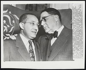 Getting an Earful-- Branch Rickey (right), president of the Brooklyn Dodgers, gets in close as he talks with Fred Saigh, St. Louis Cardinals president, at the Dodgers' pennant dinner here last night. Rickey said he's after at least one experienced pitcher. "The Cardinals have more pitchers then they can use," he declared in an interview. "By making a trade with us, perhaps they'll strengthen themselves against the rest of the league. That's the thing a team must do to win.