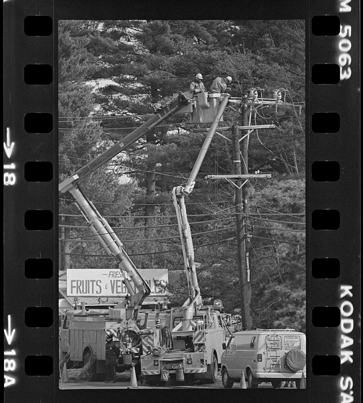 Electric company tending wires