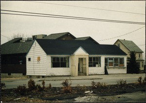 Wooden building with three boarded-up windows