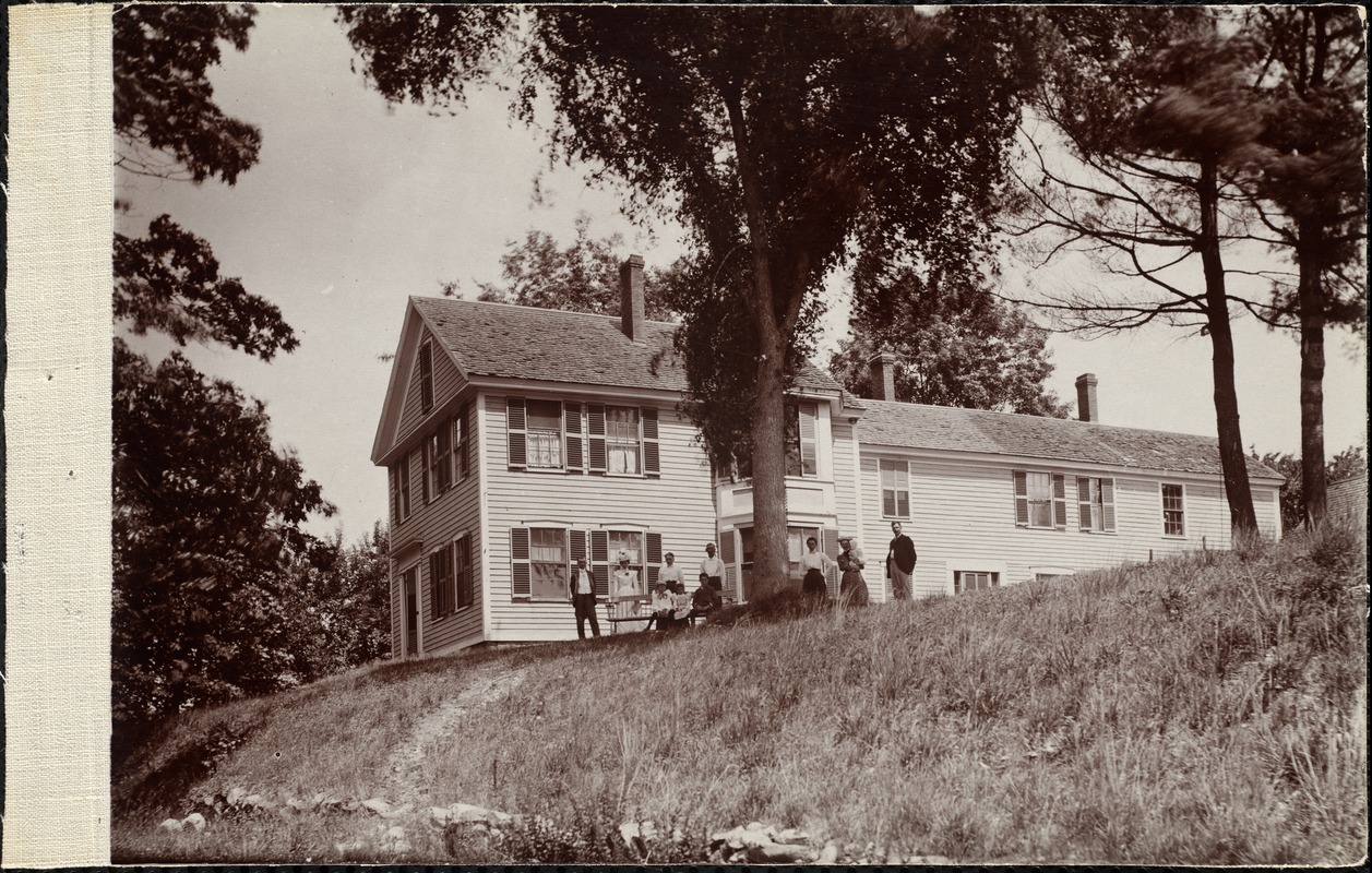 Group of people standing outside of a house