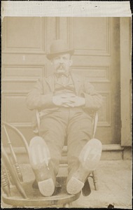 Unidentified man sitting in a chair with his feet up
