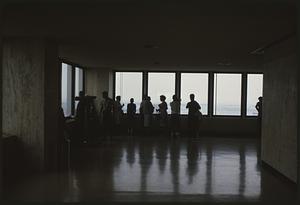 People looking out windows at apparent observatory, Boston