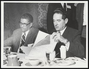 Brandeis University President Morris B. Abram, right, studies notes last night for address to New England conference of the American College Public Relations Assn.