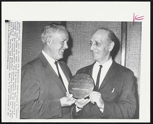 Cited For Meritorious Service -- Lester H. “Buster” Sheary, left, former Holy Cross coach from Worcester, Mass., receives a plaque “for meritorious service” from Anthony Gentile at the annual awards luncheon of the Collegiate Basketball Officials Association, Inc., in New York today. Gentile, from Winchester, Mass., is a past president of the C.B.O.A.