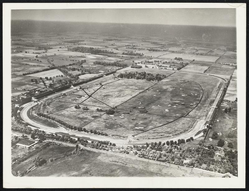 Scene Of 500-Mile Motor Race. Indianapolis, May 22 -- Here is a view of the Indianapolis Motor Speedway where annually the outstanding drivers of the Nation View on Memorial Day in a 500-mile race. In this photo, taken from an American Airlines Plane, the main grandstands are along the straightaway at the left center.