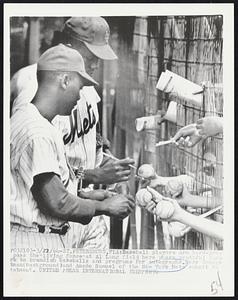 St. Petersburg, Fla. - Baseball players are hard-press pass the "living fence" at Al Lang Field here where youthful fans+E1691 to brandish baseballs and programs for autographs. Here George Altman (background) and Amado Samuel of the New York Mets submit to treatment.